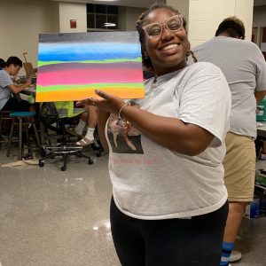 Student shows off her colorful art