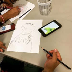 Student sketches Kermit the frog