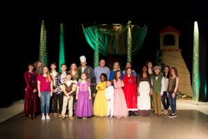 Children pose together on stage for production of Into the Woods