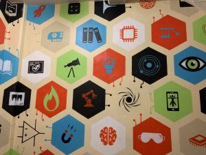 a wall filled with hexagons with different scientific icons in the center.