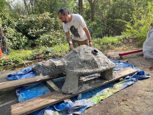 Nico works on the cement portion of his tortoise sculpture