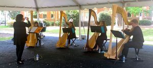 UNC Harp Ensemble plays in the tent outside of Hill Hall