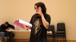 Someone acting and holding a script book